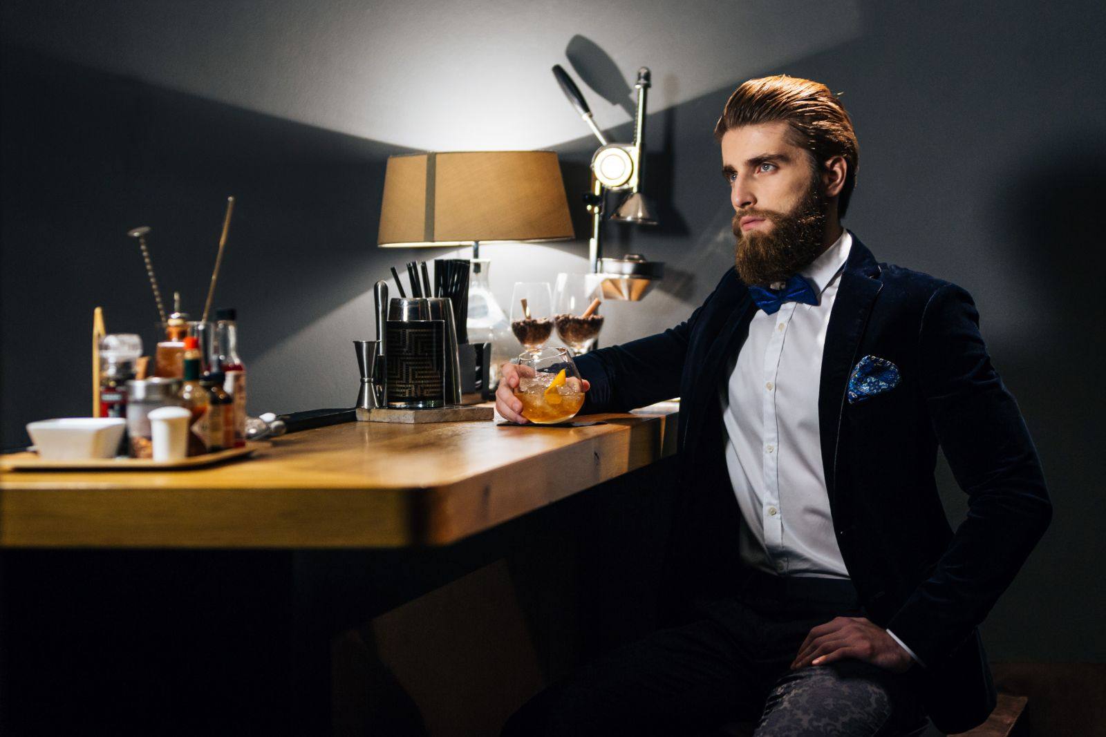 A guest at the bar with a cocktail