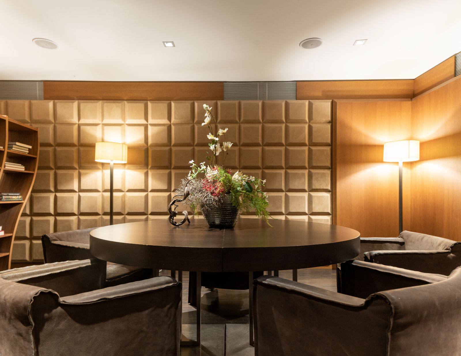 A round table set between padded walls in the library