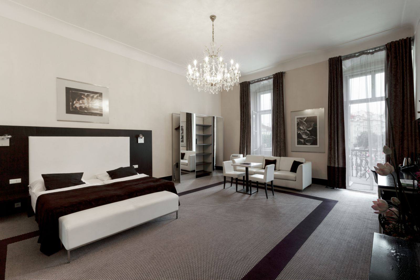Junior suite at Old Town Square Residence, with a crystal chandelier and a balcony over the square
